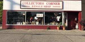 a red and white building with a sign that says collectors corner resale shop