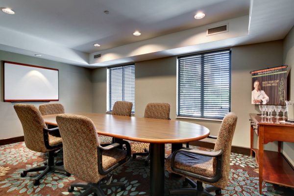 A conference room with a table and chairs.